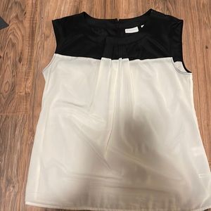 Black and white sleeveless blouse